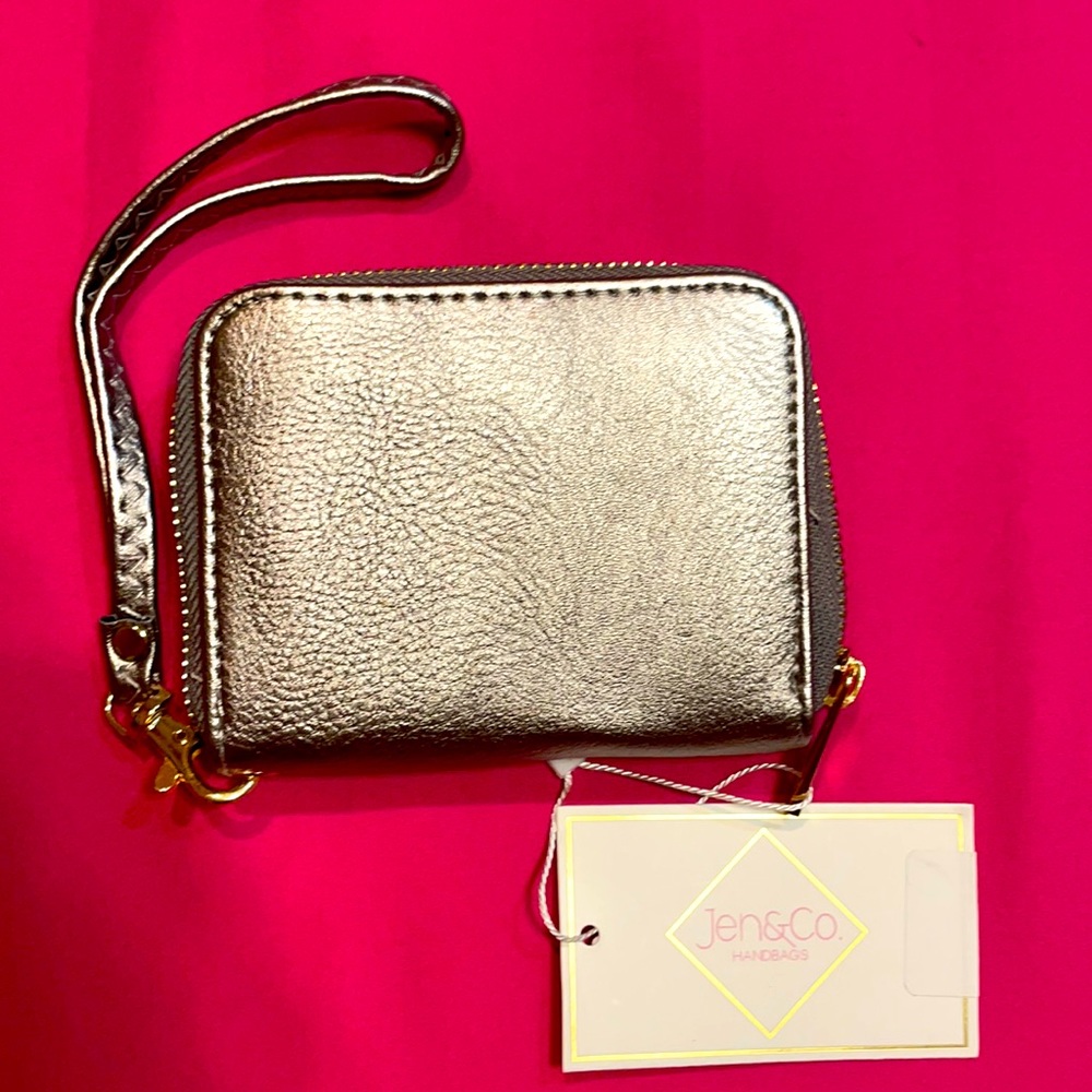 Cute wristlet wallet. Darker silver color.